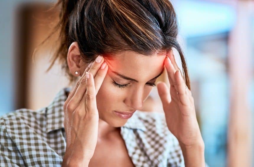 A woman suffering from headache due to oversleeping
