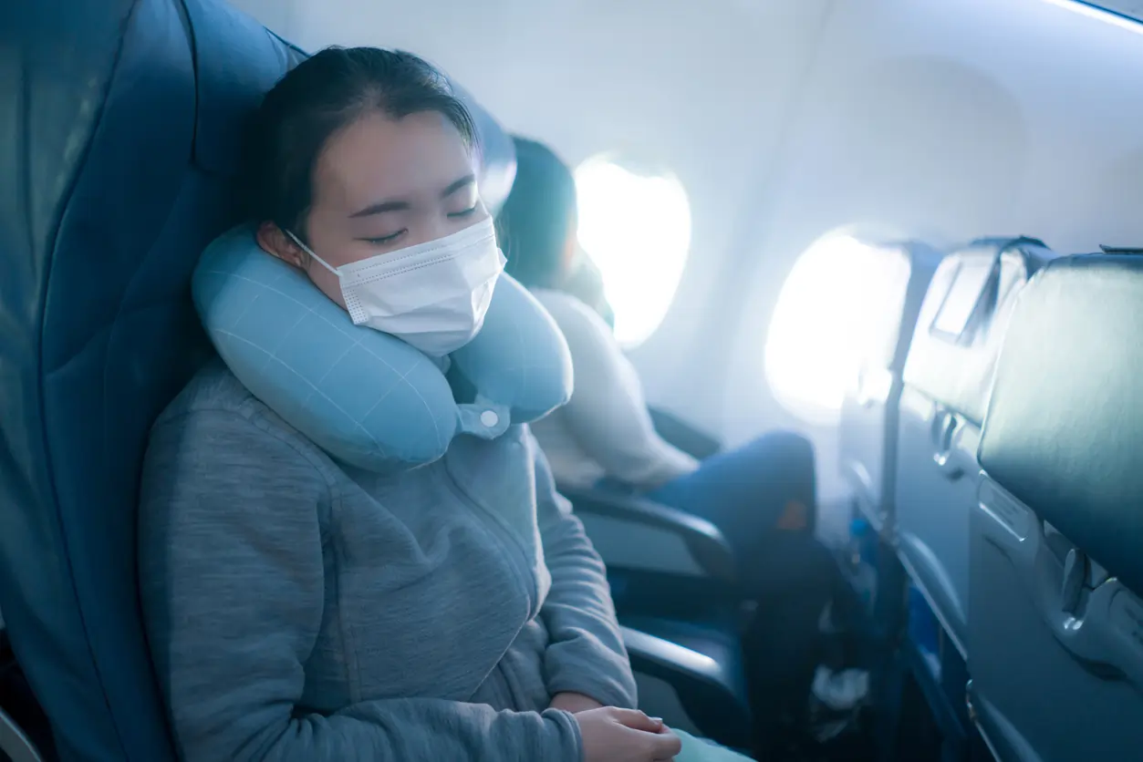 women sleeping on a plane